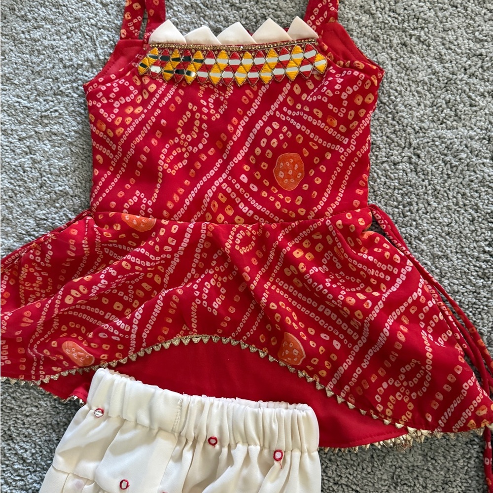 Red and Orange Patterned Sleeveless Top with White Shorts